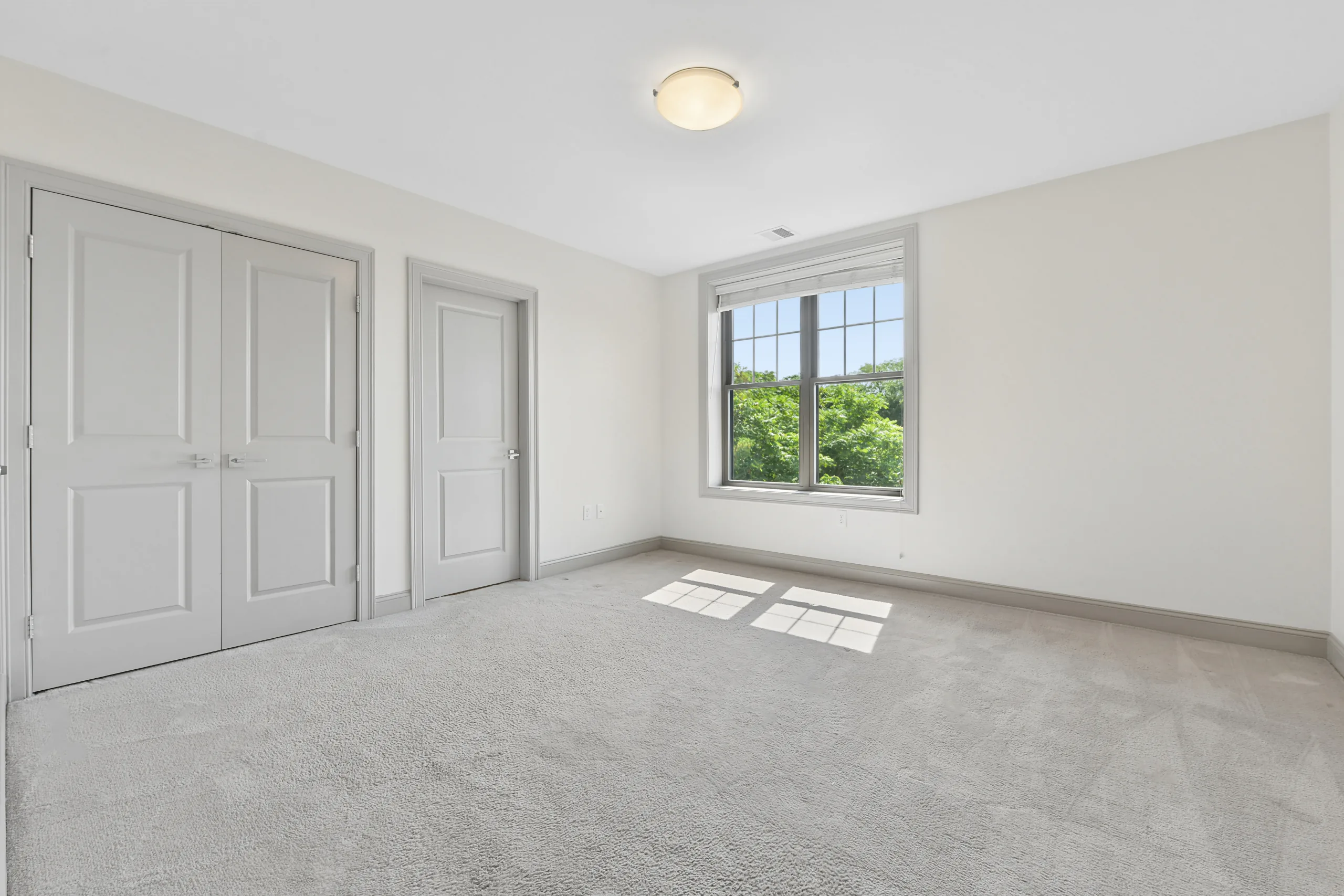 Carpeted bedroom with double closets at 1580 River St #4D