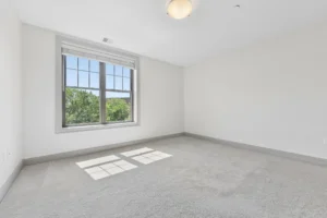 Carpeted bedroom with window at 1580 River St #4D