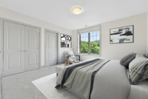Virtually staged carpeted bedroom with double closets at 1580 River St #4D