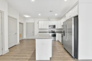 Kitchen with stainless steel appliances and centre island at 1580 River St #4D