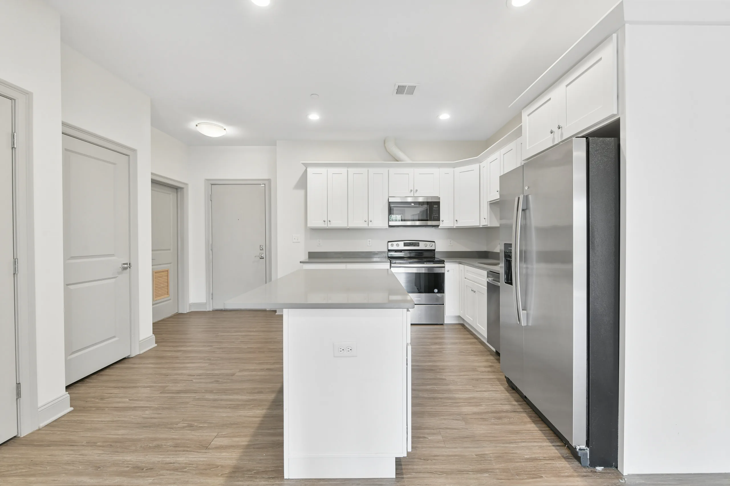 Kitchen with stainless steel appliances and centre island at 1580 River St #4D