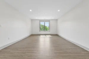 Bright living room with large window at 1580 River St #4D