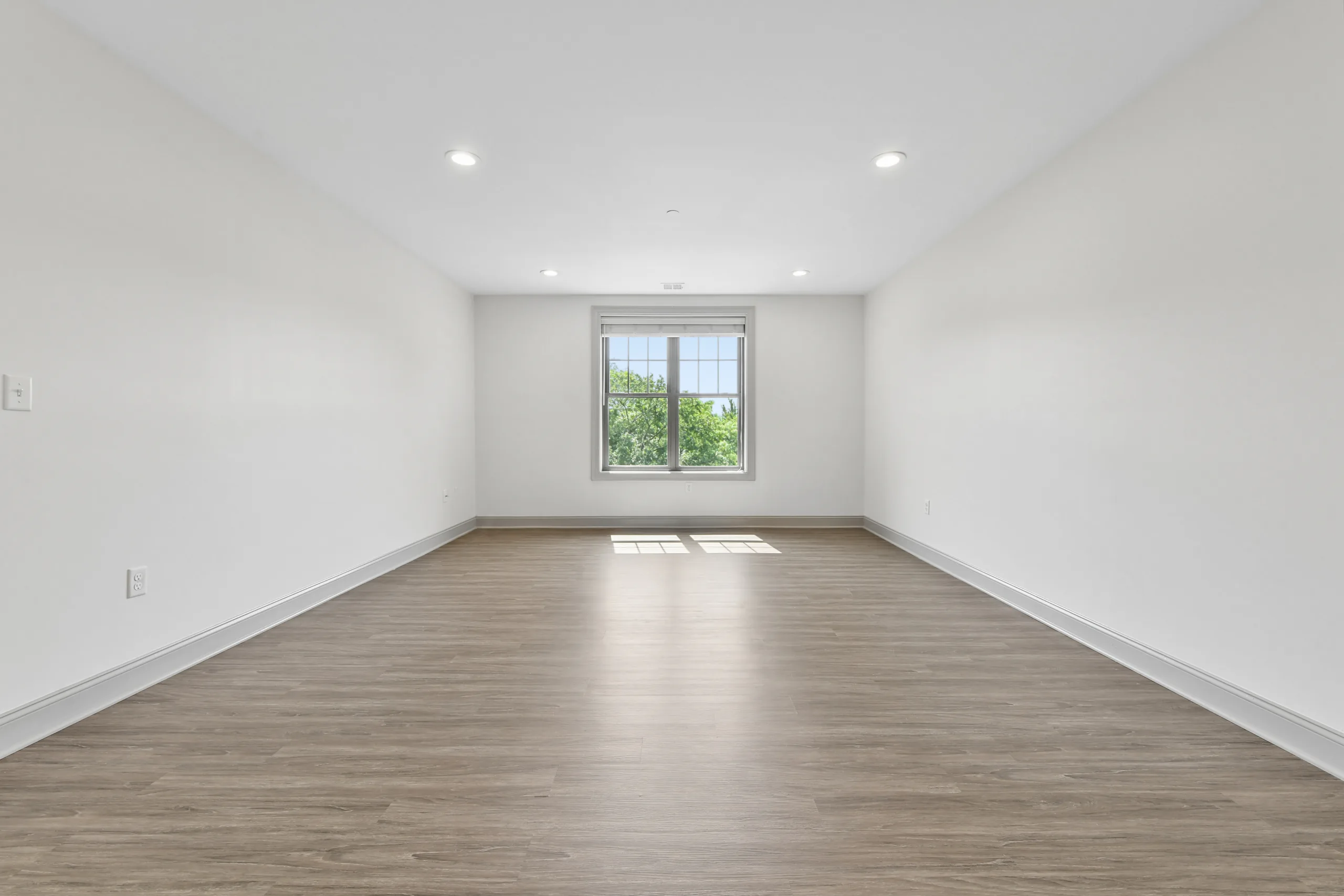 Bright living room with large window at 1580 River St #4D