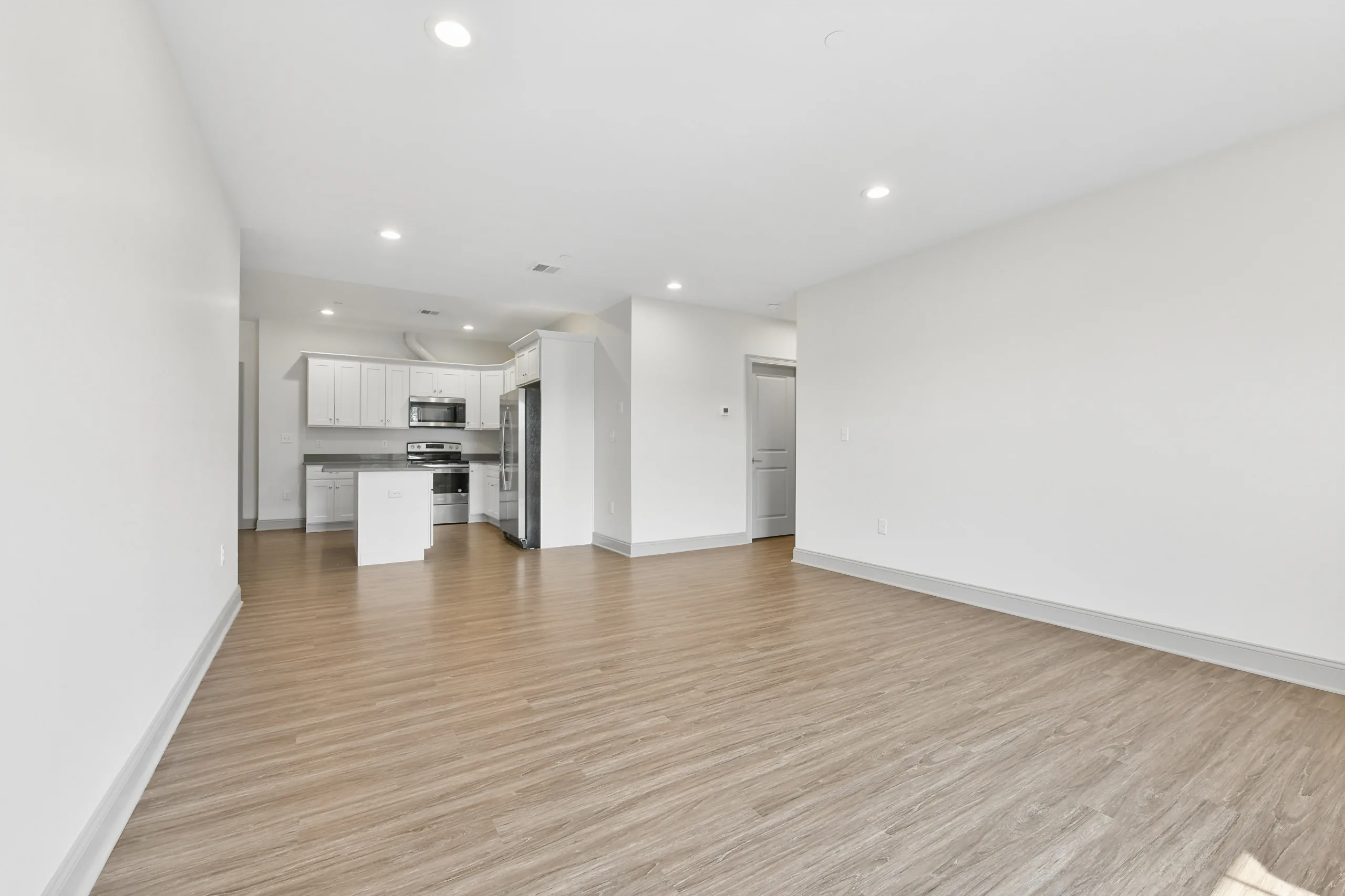 Living space with kitchen beyond at 1580 River St #4D