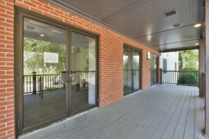 Covered porch and resident entrance at Thread Hyde Park, 1580 River St