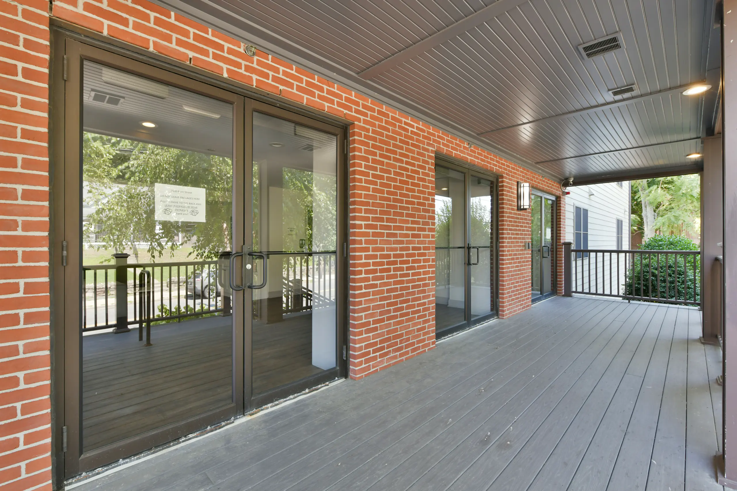Covered porch and resident entrance at Thread Hyde Park, 1580 River St
